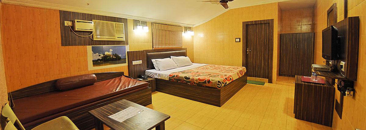 Room with kingsize bed, sofa-cum-bed, television, studying table, fan & Air conditioner, intercom in Bluebay beach resort