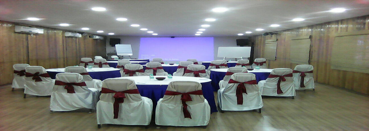 Conference hall in Bluebay beach resort, ECR, Chennai, in which the seating arrangements are made in cabaret style.  The hall has got a projector, white boards, a stage with mic, speaker arrangements and airconditioners.