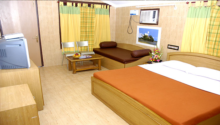 Standard room with king size bed, television with set top box, sofa-cum-bed, chairs with table, Airconditioner in Bluebay beach resort, ECR, Chennai