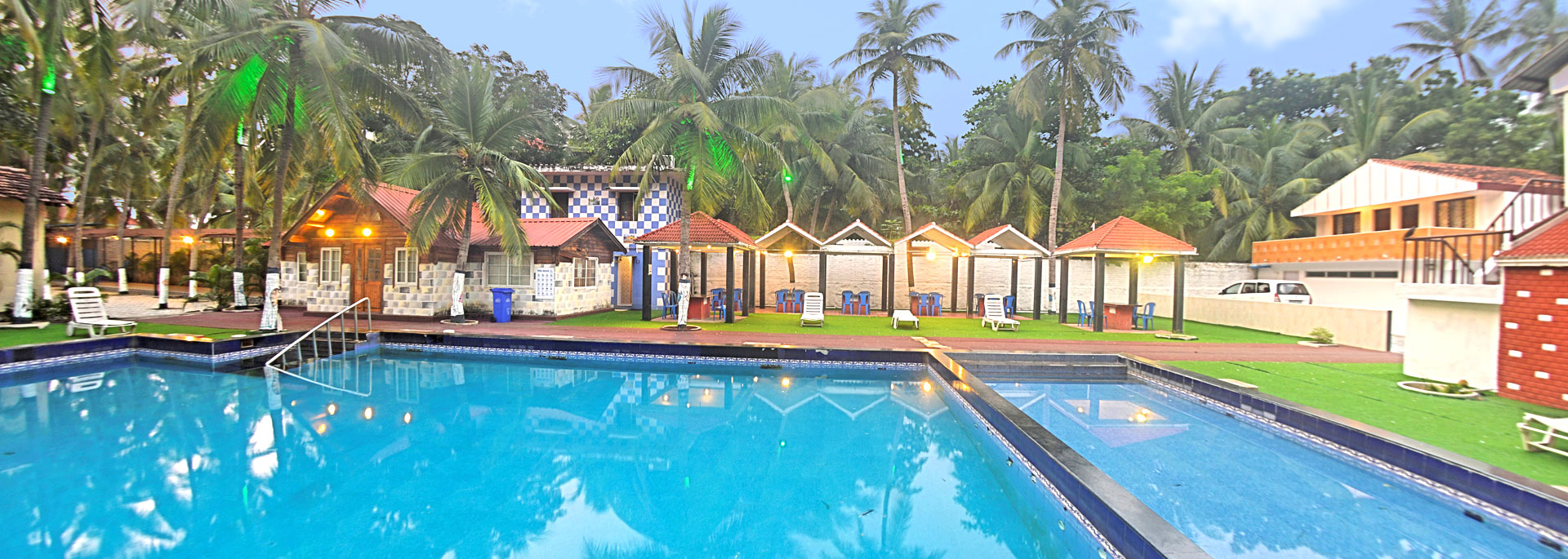 Swimmingpool with loungers, canopies in Bluebay beach resort, ECR, Chennai
